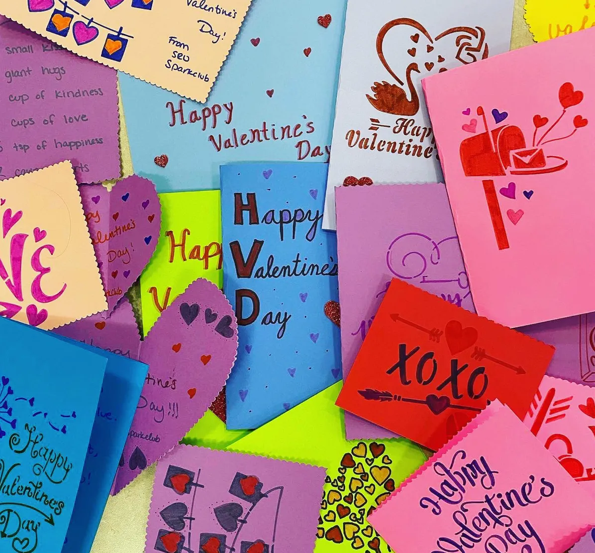 A pile of colorful handmade Valentine's Day cards made by a SPARK club